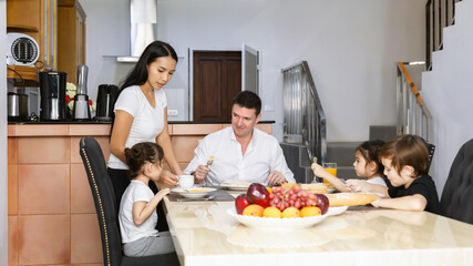 Happy family while eating breakfast together. Happy family Concept.