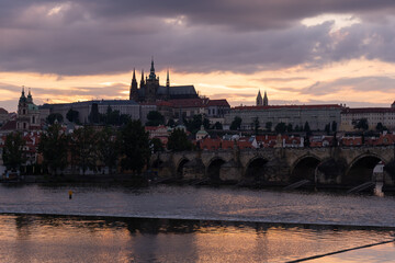 Charles Bridge, Prague Castle, St. Vitus Cathedral and the flowing Vltava River and the roofs of...