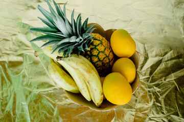 top view of a fruit basket on a golden background