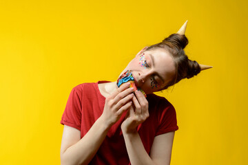 young european woman with colorful cupcake