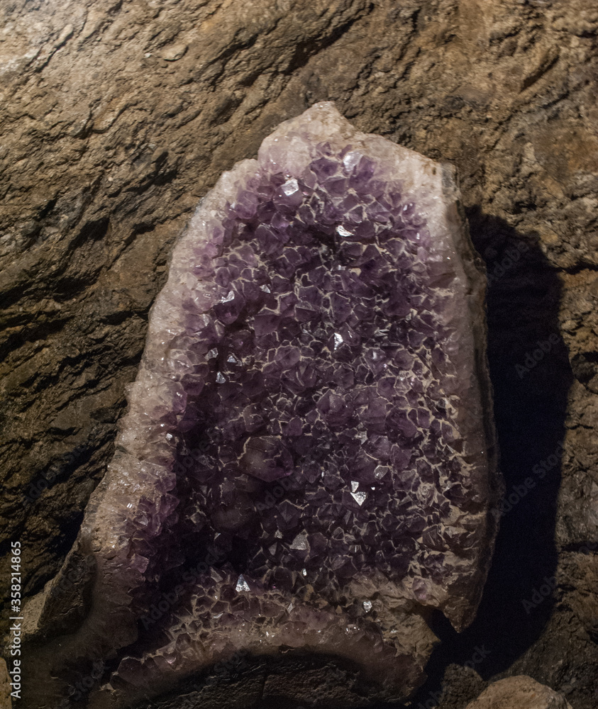 Wall mural Violet Crystal Stone macro mineral. Purple rough Amethyst quartz crystals geode