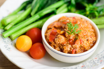 Northern Thai food (Nam Prik Ong), Spicy chili paste minced pork with tomatoes in a bowl eating with vegetables