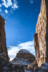 Sun shining through The Narrows covered by snow at Capitol Reef National Park