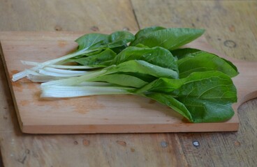 fresh pakchoi cabbage on a chopping board