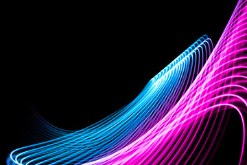 Abstract rainbow neon glowing crossing lines pattern. Dark  background of colorful neon glowing light shapes...