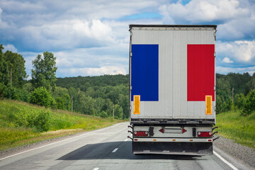 A  truck with the national flag of France depicted on the back door carries goods to another country along the highway. Concept of export-import,transportation, national delivery of goods © Виталий Сова