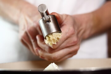 Garlic crushed using a garlic press. Making Lasagna Bolognese Series.