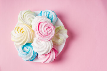 Homemade sweet colored meringue on pink background.  .Dessert.
