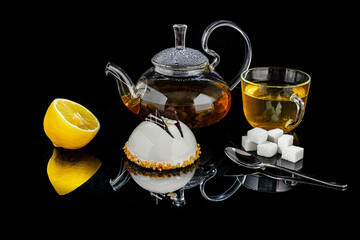 black tea with lemon on a black background hot