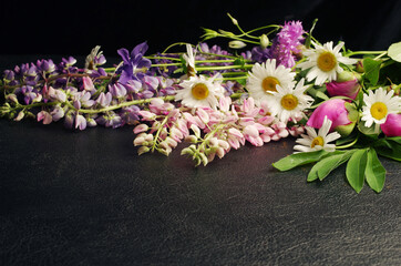 Wildflowers on a black plastic background