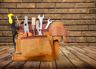 Leather bag with set of tools on desk