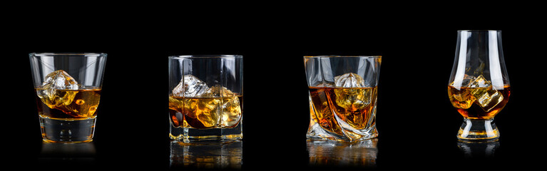 Set of four glass of whiskey with cube ice on black background