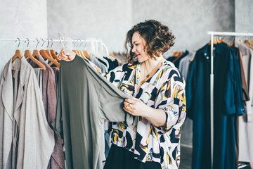  Plus Size Woman Choose Fashioned Dress in Store. Plus size women shopping.