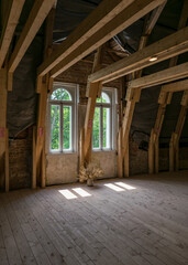 wooden beams and windows in the roof attic