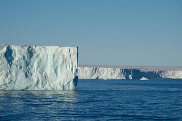 Tabular iceberg at a place called "Nordaustlandet" on Svalbard. Blue sky and blue water