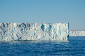 Tabular iceberg at a place called "Nordaustlandet" on Svalbard. Blue sky and blue water