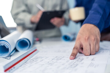 Architect working on blueprint. Architects workplace - architectural project, blueprints, ruler, calculator, laptop and divider compass. Construction concept. Blue print is fake only for stock photo.
