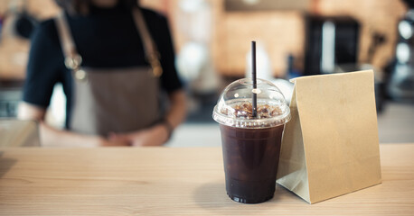 Barista  in apron and face mask standing  behind counter bar ready to give Coffee Service at the modern coffee shop, Modern cafe business, Social distancing concept. 