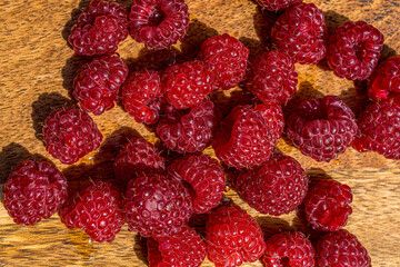 Fresh juicy raspberry close up macro on a wood background. Nature background. Fresh fruit. High quality photo
