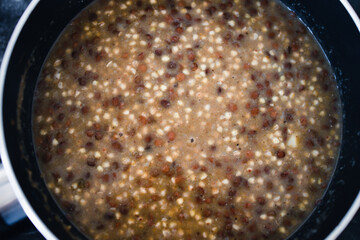 plant-based food, vegan potato and leek buckwheat with lentils in pot on stove