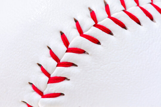 Macro of a baseball surface with stitching.