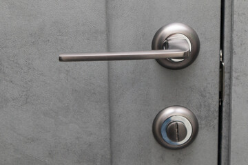 Exterior door handle. Gray metal doorknob