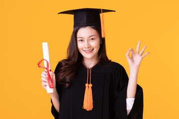 Happy Graduate asian woman in cap and gowm holding Certificated