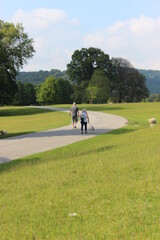 Man, woman and dog walking in the grounds of Chatsworth, Bakewell, Derbyshire, England in summer 