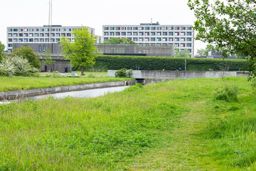 nice landscape with water and a building on a green field