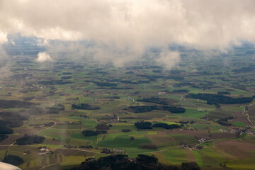 Clouds over small parcels of soil fields, aerial view