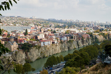 Fototapeta na wymiar Tbilisi, Georgia - October 21, 2019: Top view on the old part of the city Tbilisi in Georgia in a day