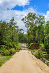 Fototapeta na wymiar Concrete floodway on Tableland Road, Queensland