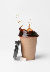Cup of hot coffee with splash on white background