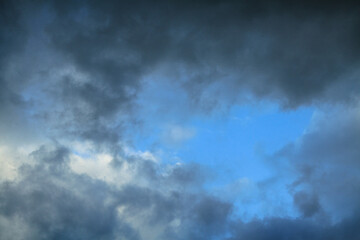 Picturesque clouds in the sky. Window view of an airplane on a sunny gloomy day. Stock photo background