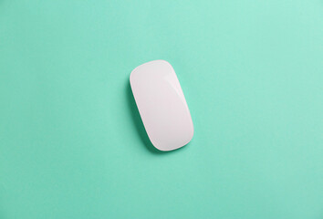 Modern computer mouse on color background