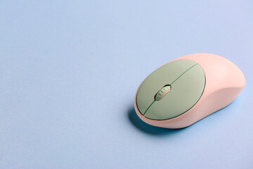 Modern computer mouse on color background