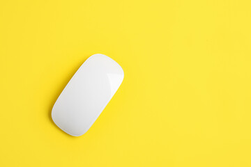 Modern computer mouse on color background
