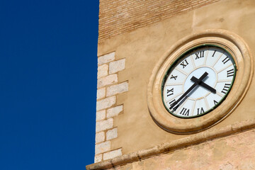 Fototapeta na wymiar Old stone tower with clock in Spain