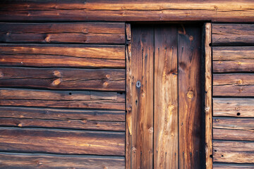 Old, viking wooden door on wooden timber wall