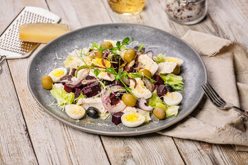 Close-up beets salad with ice lettuce, sweet onions, sheeps spicy cheese, olives, micro-greens and olive oil. Mediterranean diet.