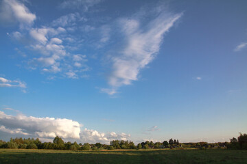 Beautiful summer landscape of nature countryside. Green vegetation of grass and trees with hills. Stock photo for design