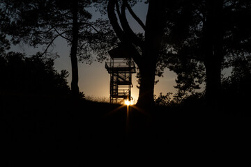 Silhouette of nature observation tower in sunset
