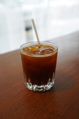 Close up iced black Americano coffee on wooden table