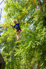Girl bungee jumping in trampoline