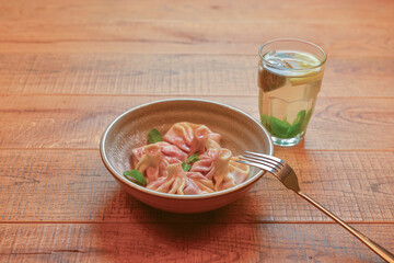 Sweet khinkali with cherry served on a wooden table. Traditional Georgian desserts. Georgian cuisine.
