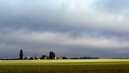 cloudy sky and sun light on agricultual fields in brie region