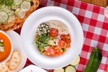 Dietary salad with vegetables, cheese feta, arugula and sauce. Traditional Italian cuisine, Italian concept.