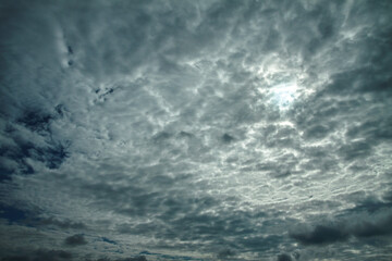 Picturesque clouds in the sky. Window view of an airplane on a sunny gloomy day. Stock photo background