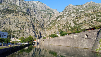 Obraz premium old wall of old town Kotor in Montenegro and light gray mountains