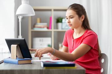children, education and learning concept - teenage student girl with tablet pc computer and notebook at home